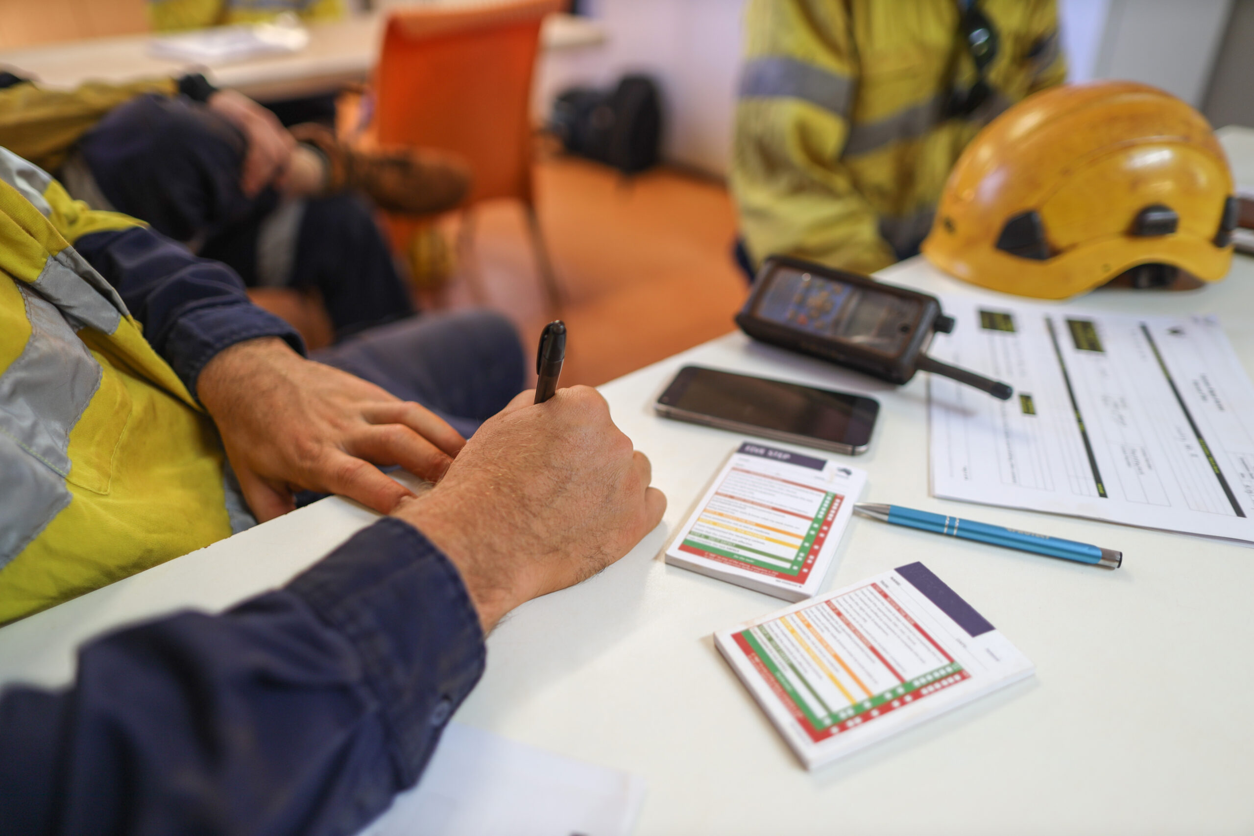 Miner workers conducting writing self risk assessment take five safety step controlling prior to work each task construction site, Perth, Australia